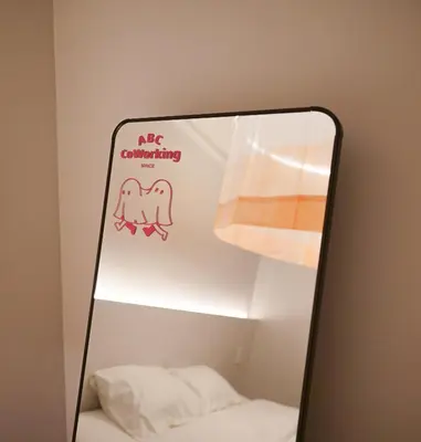 a mirror with a sign that says no orthodontining at ABC Bangkok RCA in Bangkok