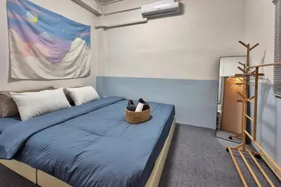 a bedroom with a bed with a basket on it at Townhouse at Yaek Lam Sali station for 6 pax in Ban Bang Toei (1)