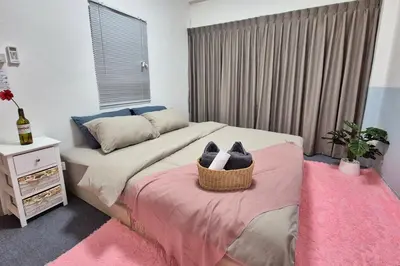 a bedroom with a bed with a basket of shoes on it at Townhouse at Yaek Lam Sali station for 6 pax in Ban Bang Toei (1)