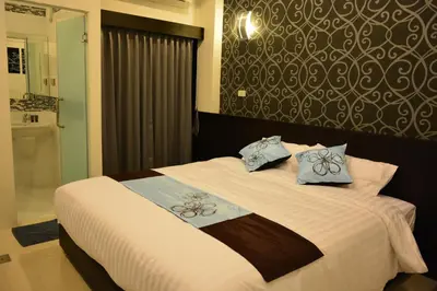 a bedroom with a bed with two pillows on it at Adamaz House in Bangkok