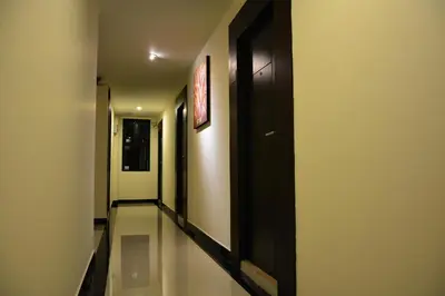 a hallway with black doors and glass floors and a hallway at Adamaz House in Bangkok