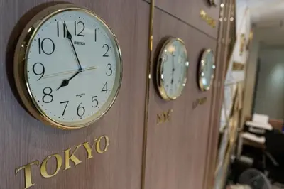 four clocks on a wall with tokyo on it at Adamaz House in Bangkok