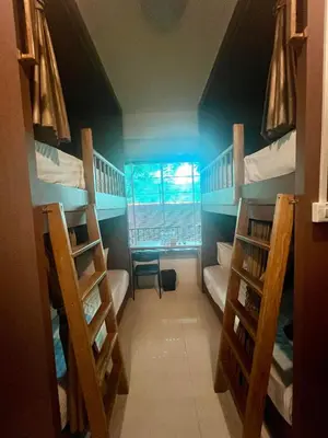 a room with three bunk beds and a window at Adamaz House in Bangkok