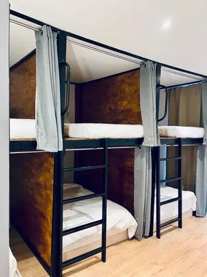 a group of bunk beds in a room at The Motuga Hostel Bangkok in Bangkok