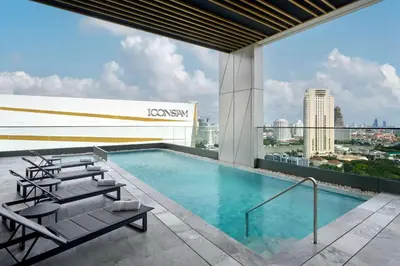 a swimming pool on the roof of a building at Hilton Garden Inn Bangkok Riverside in Bangkok
