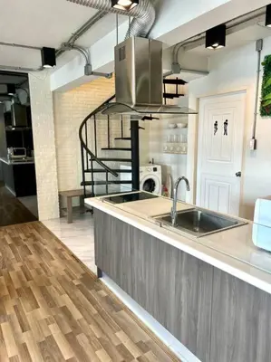 a kitchen with a sink and a stove at Cozy 2BR Duplex-Apartment in Thong Lor in Bangkok