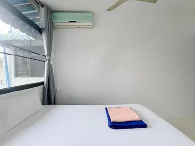 a bed in a hospital room with a towel on it at V Reserve at Merry V in Bangkok
