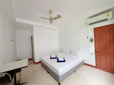 a bedroom with a bed with blue shoes on it at V Reserve at Merry V in Bangkok