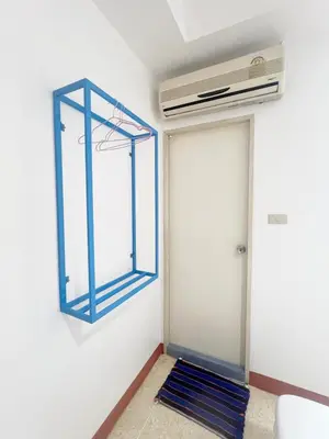 a room with a door with a fan on the wall at V Reserve at Merry V in Bangkok