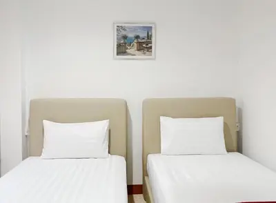 two beds sitting next to each other in a room at V Reserve at Merry V in Bangkok
