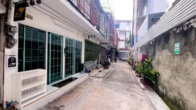 a hallway of a building with windows and plants at uouRangnamHouse in Bangkok