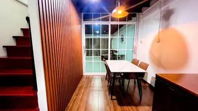 a dining room with a table and a window at uouRangnamHouse in Bangkok