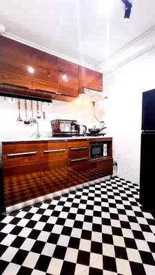 a kitchen with a black and white checkered floor at uouRangnamHouse in Bangkok