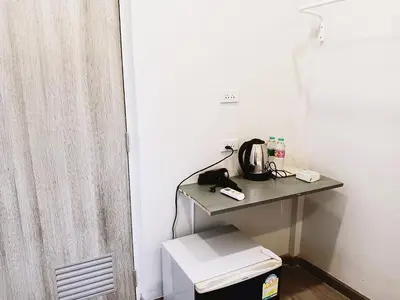 a room with a table with a tea kettle on it at Hidden Dragon Yaowarat MRT วัดมังกร in Samphanthawong