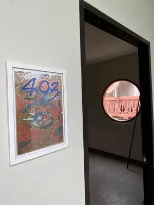 a framed painting on a wall next to a mirror at Hidden Dragon Yaowarat MRT วัดมังกร in Samphanthawong
