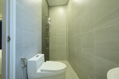 a bathroom with a white toilet and a sink at Hidden Dragon Yaowarat MRT วัดมังกร in Samphanthawong