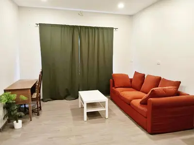 a living room with a red couch and a table at XX HD China Town MRT Dragon Temple in Samphanthawong