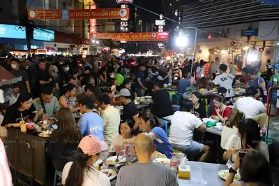 a crowd of people sitting at tables in a market at XX HD China Town MRT Dragon Temple in Samphanthawong