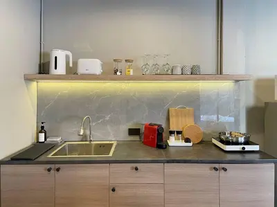 a kitchen with a sink and a counter top at Vélin Khaosan - 5th Floor apartment with 2Bedrooms in Bangkok