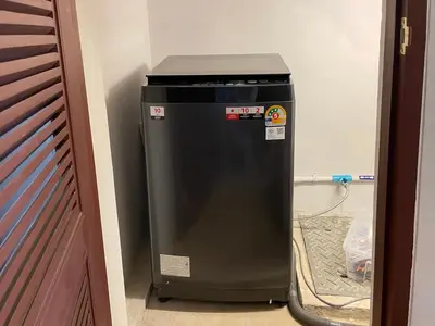 a black trash can in a room next to a door at Vélin - Chinatown in Khlong San