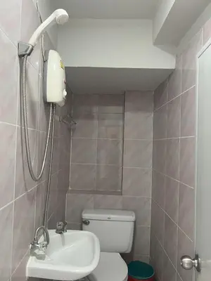 a bathroom with a shower and a toilet and a sink at Bella Bella House in Bangkok
