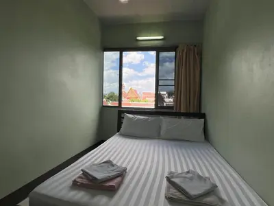 a bedroom with a bed with two pillows on it at Bella Bella House in Bangkok