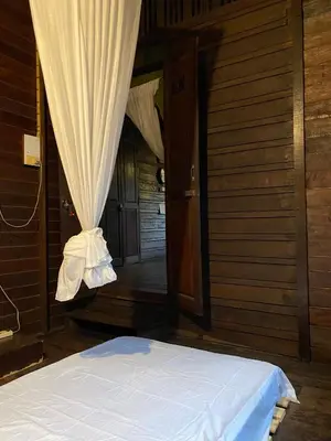 a bed in a room with a curtain at Chest's Place in Bangkok