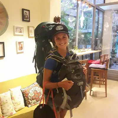 a young girl with a backpack on her back at Good Day Hostel in Bangkok