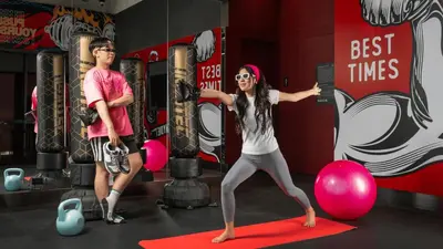 a man and a woman doing yoga in a gym at Cassia Rama 9 Bangkok, part of Banyan Group in Bangkok