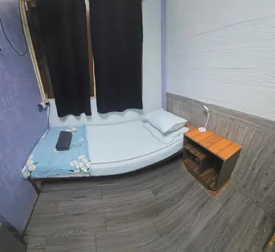 a small bed and a bench in a room at 204 Olan Place Spacious Studio with Wi-fi near BTS Skytrain in Bangkok