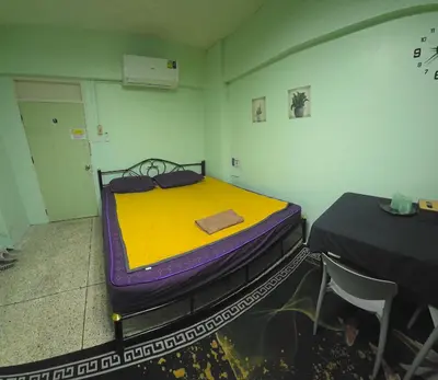 a room with a bed sitting on a cart at Spacious Studio with Private kitchen near Skytrain in Bangkok