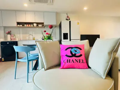 a couch with a pink pillow on it in a kitchen at New Ekamai Thonglor Luxury Home near 711, BTS, Mall in Khlong Toei