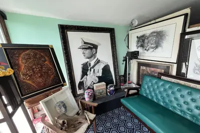 a room with a couch and pictures of a man at 64 Sweet Home Dusit BKK in Bangkok