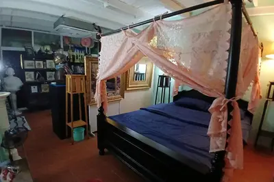 a bedroom with a bed with a canopy at 64 Sweet Home Dusit BKK in Bangkok