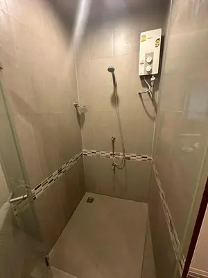 a bathroom with a shower with a walk in shower at Le Ram Hotel No windows in Bangkok