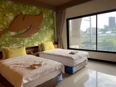 two beds in a room with a large window at Le Ram Hotel No windows in Bangkok