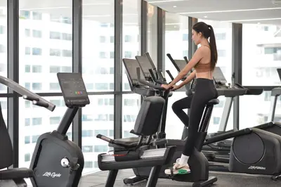 a woman on a treadmill in a gym at GM Estate Hotel and Executive Apartments, Bangkok Sukhumvit 20 in Bangkok