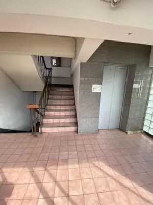 a hallway with a staircase in a building at รัตนากร แมนชั่น in Bang Su
