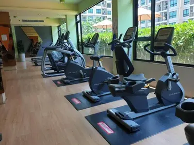 a row of exercise bikes in a gym at Home at Sena in Bangkok