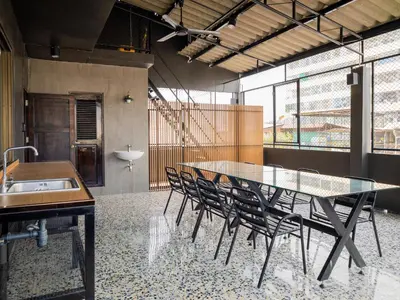 a dining room with a glass table and chairs at home22 Private Residence in Bangkok