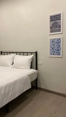 a bedroom with a bed and two pictures on the wall at xx HD Yaowarat Road BKK in Samphanthawong