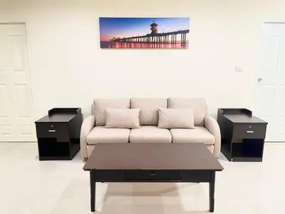 a living room with a couch and a pier at Charming Resident Sukhumvit 22 in Bangkok