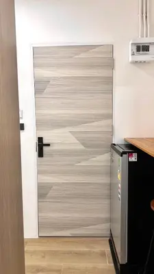 a sliding door in a room with a kitchen at 65 Hostel Bangkok in Bangkok Noi