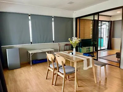 a dining room with a table and chairs at Kirin Riverside Homestay with AC, WiFi in Bangkok in Rat Burana