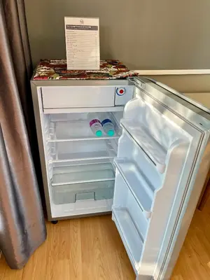 an empty refrigerator with its door open in a kitchen at Kirin Riverside Homestay with AC, WiFi in Bangkok in Rat Burana