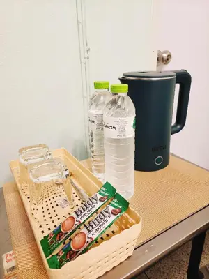 a table with a basket of milk and water bottles at 805-STP Homely room Free Wi-Fi and Near BTS line in Bangkok