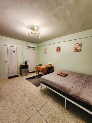 a bedroom with a bed and a table in it at 805-STP Homely room Free Wi-Fi and Near BTS line in Bangkok