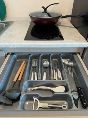 a frying pan on top of a stove in a kitchen at Modern Condo Near Icon Siam & BTS Krung Thonburi in Bangkok