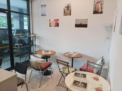 a room with two tables and chairs and a window at Merlin MANSION 107 in Ban Khlong Samrong