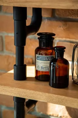 two bottles of honey on a wooden shelf at Parrish Serviced Apartment in Bang Mote
